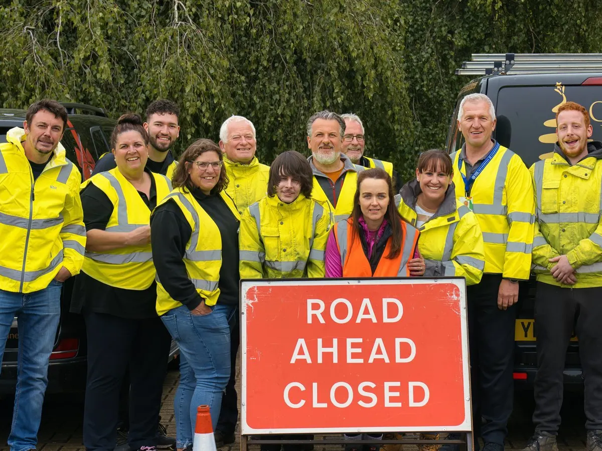 Chapter 8 cohort in hi-vis behind a Road Ahead Closed sign on a practical